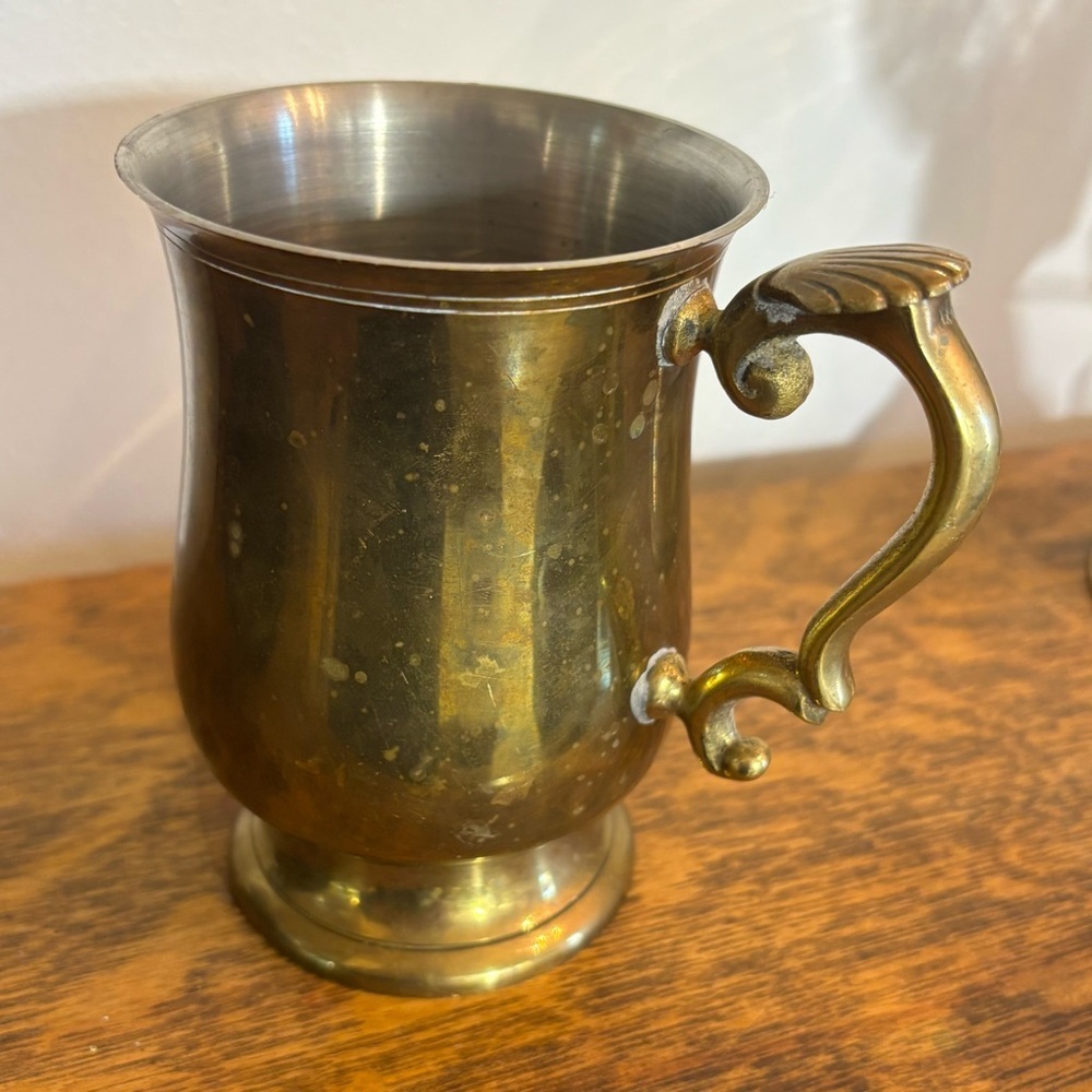 Vintage brass footed mug / tankard with shell embellishment on handle